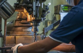 Milling machine operator workin at a machine shop.